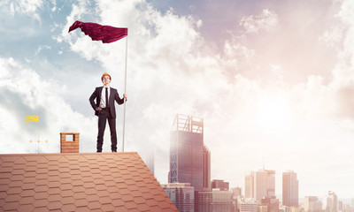 Young businessman with flag presenting concept of leadership. Mi