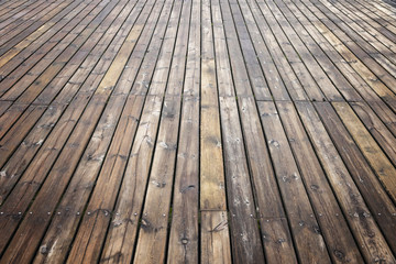 Old wooden brown background texture with perspective. Wooden planks that make up a large pier