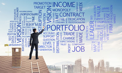 Young businessman standing on house roof and writing leadership 