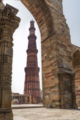 Lady passing through courtyard in Qutub complex in Mehrauli, Delhi, India, Asia.