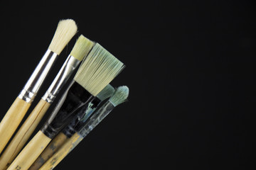 painting brushes on black background