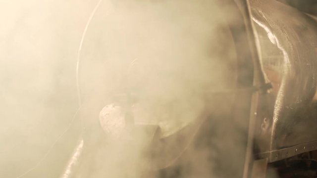 Coffee beans fall from roaster to cooling cylinder