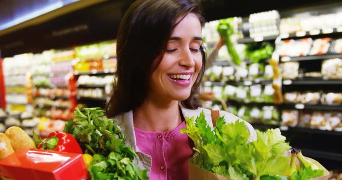 Couple selecting vegetables from organic section