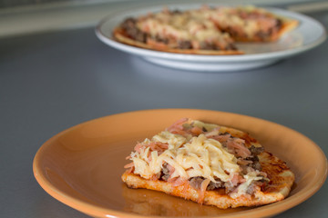 Frittata with tomato sauce, carrot, fried minced beef and cheese on white plate.