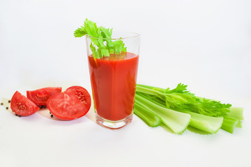 Glass of tomato juice with selery, pepper, carrot and tomatoes