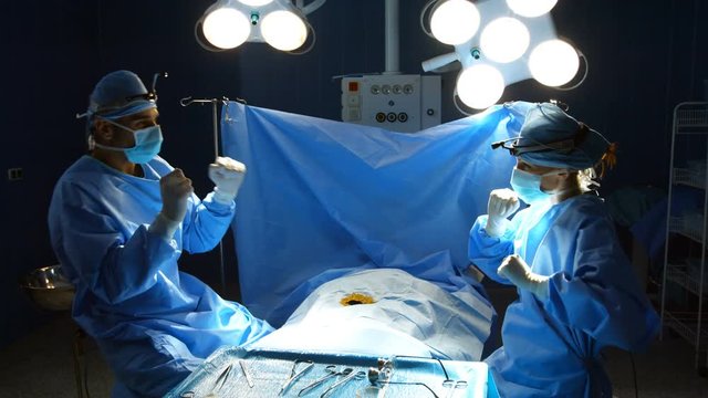 Surgeons dancing after performing a successful operation