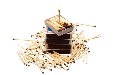 Matches in boxes and in bulk isolated on white background, and one standing burning match