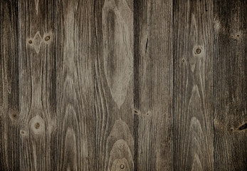 Obraz premium Old weathered wood surface with long boards lined up. Wooden planks on a wall or floor with grain and texture. Dark neutral tones with contrast.