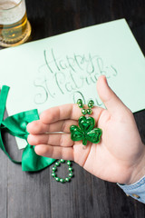 Man holding green clover necklace