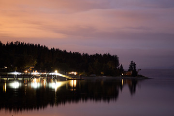 Purple sky reflecting water and lights