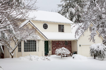 Residential home.  Average american two story residential home covered with snow during winter storm.