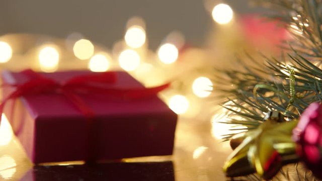 Gift box with christmas decoration and lights boken on the background