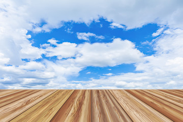 Perspective wooden board empty table top over beautiful blue sky