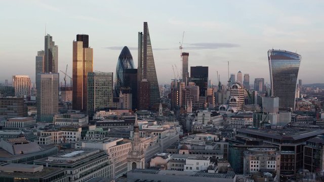 Establishing shot elevated view - day to night time-lapse of the business district of London England