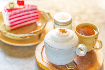 A cup of  coffee and a piece of cake.