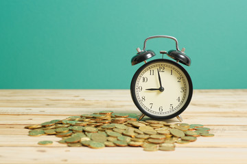 Alarm Clock with Gold Coins - Financial Wealth Concept