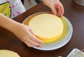 Cake in process on stand on wooden table, Homemade Cake.