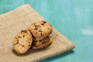 Chocolate chips cookies on burlap and blue textures