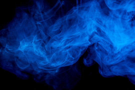 Abstract smoke Weipa. Personal vaporizers fragrant steam. The concept of alternative non-nicotine smoking. Blue smoke on a black background. E-cigarette. Evaporator. Taking Close-up. Vaping.