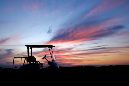 silhouette golf cart in golf course withcolorful twilight sky soft cloud for background backdrop use