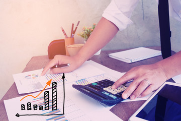 Businessmen use the calculator to calculate and analyze the comp