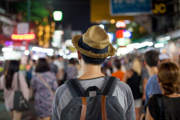 Young Asian traveling backpacker in Khaosan Road night market
