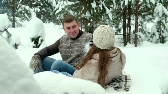 Guy and girl photographed in winter forest