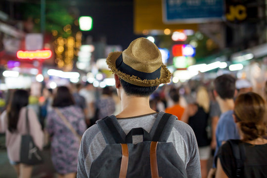 Young Asian traveling backpacker in Khaosan Road night market