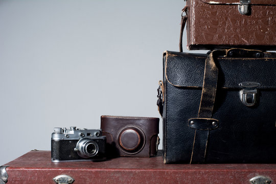 Camera and carrying case on old suitcase