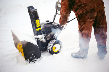 man starts the engine snow blower