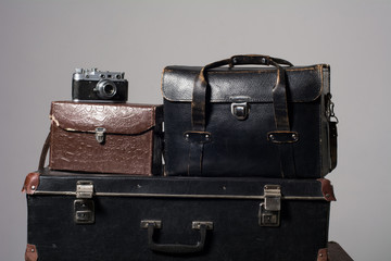 Stack of old shabby suitcases and camera