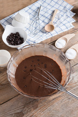 Ingredients for making cup cake chocolate on wooden background.