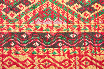 old colorful thai handcraft peruvian style rug surface old vintage torn conservation Made from natural materials Chemical free close up.