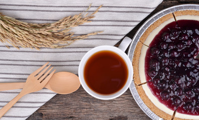 Blueberry pie and berries on rustic wooden table