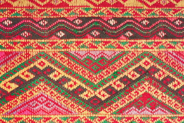 old colorful thai handcraft peruvian style rug surface old vintage torn conservation Made from natural materials Chemical free close up.