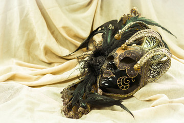 Venetian carnival mask on a bright fabric background