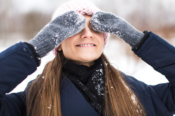 Fototapeta na wymiar happy woman mittens winter closes his eyes