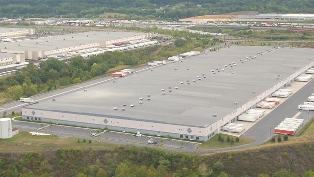 AERIAL: Large modern logistic and transportation center with big warehouses