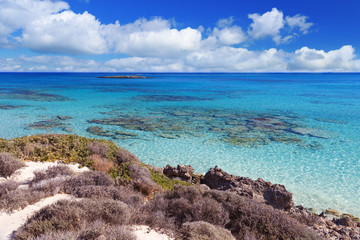 Fototapeta premium Great beach Elafonisi. Greece, Crete. Fine white sand and blue sky with clouds. Clear blue water. Shallow water. Seascape.