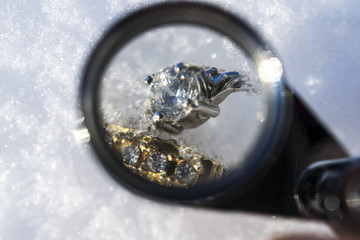 Photo material of appraiser magnifier and accessory placed on snow