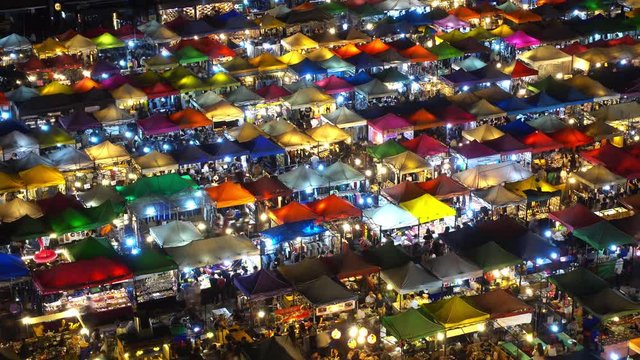 High view of colorful tent retail shop with night light at Talad Rod Fai Night Market, Ratchada, Bangkok, Thailand, timelapse 4k
