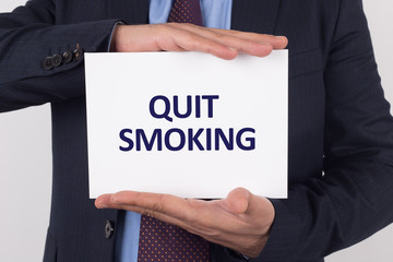 Man showing paper with QUIT SMOKING text