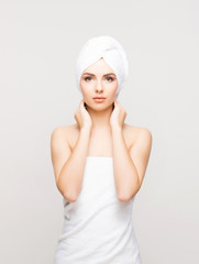 Young, beautiful woman wrapped in a towel