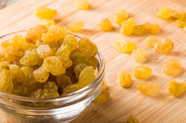 Top macro view of the big raisins in a glass bowl
