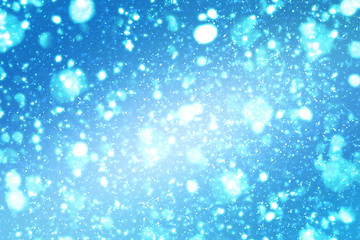 Abstract round silver bokeh or glitter lights on blue background. Circles defocused particles