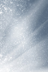 Snowflakes particles and white  bokeh or glitter lights on silver background. Christmas abstract...