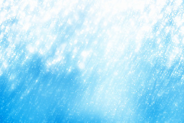 Obraz premium Abstract round silver bokeh or glitter lights on blue background. Circles defocused particles