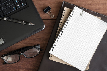 Notebook with cup of coffee on office desk