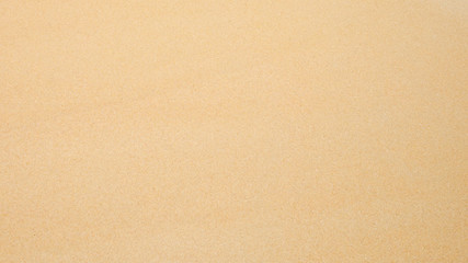 Naklejka na ściany i meble Top view of sand texture. Sandy beach for background.