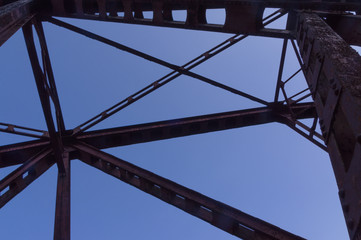 Railway bridge in woods with colorful foliage.